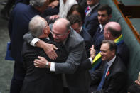 Liberal MP Warren Entsch hugs Australian Prime Minister Malcolm Turnbull after the passing of the Marriage Amendment Bill in the House of Representatives at Parliament House in Canberra December 7, 2017. AAP/Lukas Coch/via REUTERS