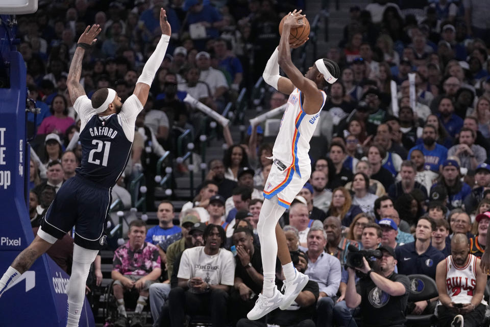 Oklahoma City Thunder's Shai Gilgeous-Alexander, right, shoots over Dallas Mavericks' Daniel Gafford (21) in the second half in Game 4 of an NBA basketball second-round playoff series Monday, May 13, 2024, in Dallas. (AP Photo/Tony Gutierrez)