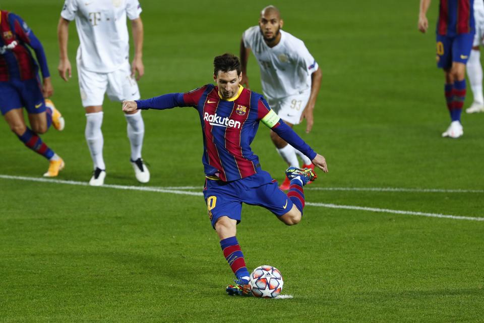 Barcelona's Lionel Messi scores a penalty during the Champions League group G soccer match between FC Barcelona and Ferencvaros at the Camp Nou stadium in Barcelona, Spain, Tuesday, Oct. 20, 2020. (AP Photo/Joan Monfort)