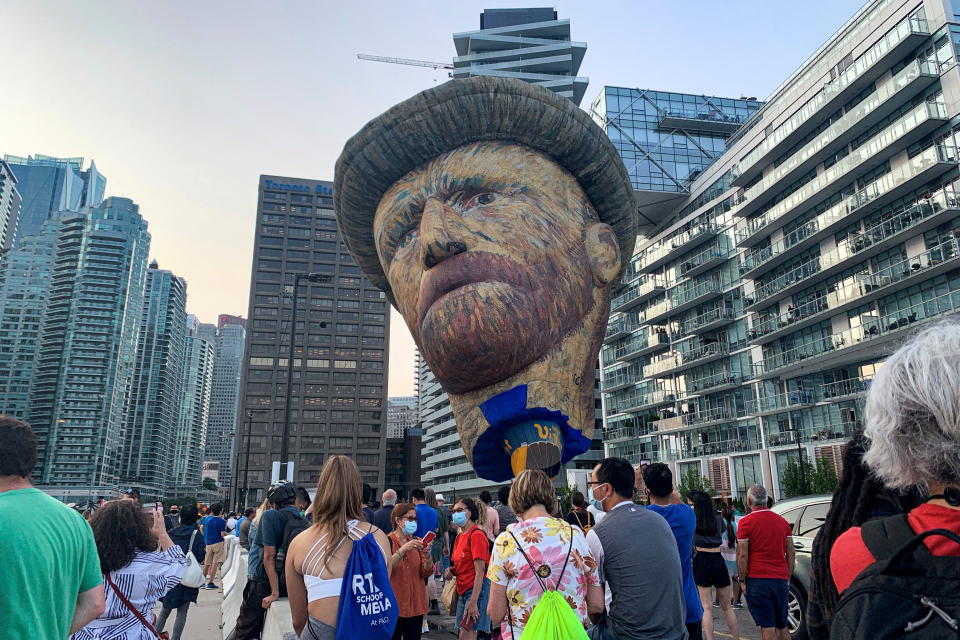 A 91-foot (28 metres) tall balloon made in the likeness of Dutch post-impressionist artist Vincent Van Gogh rises above the waterfront, as part of a promotion for the Immersive Van Gogh Exhibit in Toronto, Ontario, Canada July 28, 2021. Picture taken July 28, 2021.  REUTERS/Kyaw Soe Oo     TPX IMAGES OF THE DAY