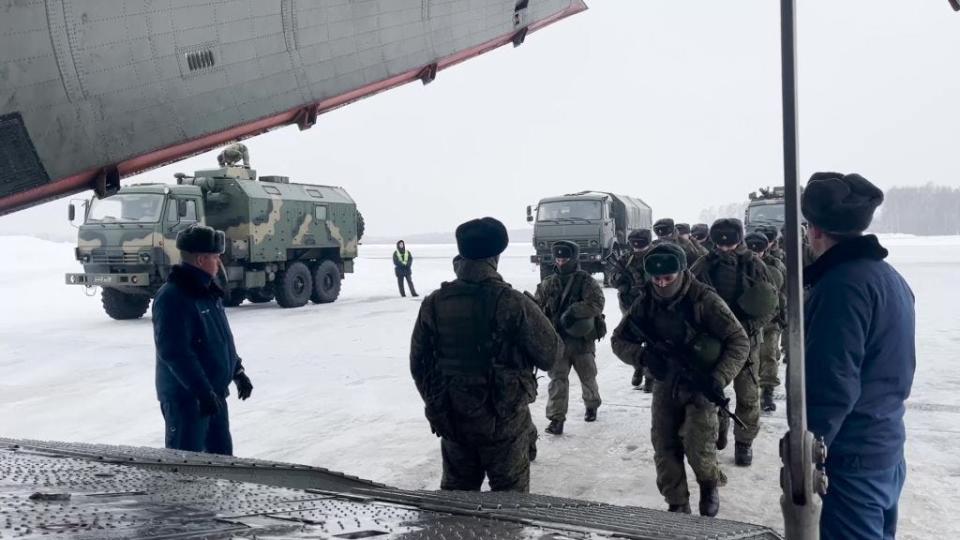 Russian servicemen boarding a military aircraft on their way to Kazakhstan