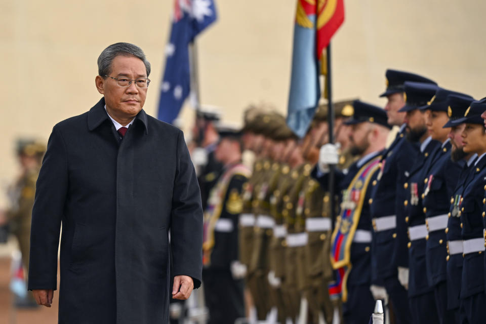 Chinese Premier Li Qiang inspects a guard of honor outside Parliament House in Canberra, Australia, Monday, June 17, 2024. Li, Australian Prime Minister Anthony Albanese and senior ministers of both administrations met at Parliament House on Monday to discuss thorny issues, including lingering trade barriers, conflict between their militaries in international waters and China's desire to invest in critical minerals. (Lukas Coch/Pool Photo via AP)