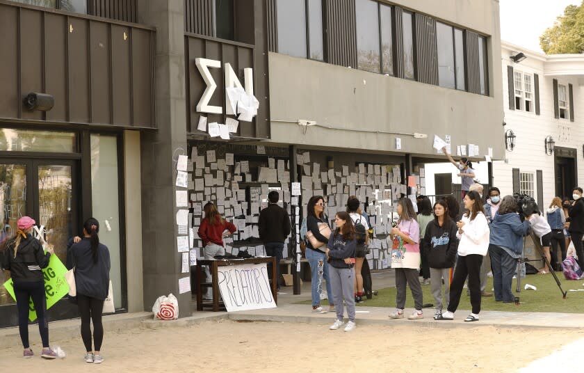 LOS ANGELES, CA - OCTOBER 22: USC students gather Friday afternoon at the Sigma Nu fraternity house near the USC campus. USC officials have placed the Sigma Nu fraternity chapter on interim suspension following allegations that women were drugged and sexually assaulted at the fraternity house. In a crime alert issued Thursday, the USC Department of Public Safety said campus officials received "a report of sexual assault" at the Sigma Nu fraternity house locate at 660 W. 28th St. "The university also has received reports of drugs being placed into drinks during a party at the same fraternity house, leading to possible drug-facilitated sexual assaults," according to the alert. USC on Friday, Oct. 22, 2021 in Los Angeles, CA. (Al Seib / Los Angeles Times).