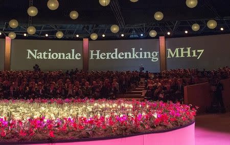 Relatives and friends of the victims of Malaysian Airlines MH17 sit under words reading "National Memorial M17", during the remembrance ceremony at the RAI convention center in Amsterdam November 10, 2014. REUTERS/Frank van Beek/Pool