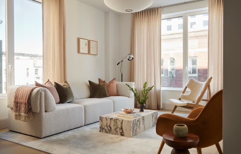 Marble coffee table in neutral toned living room.