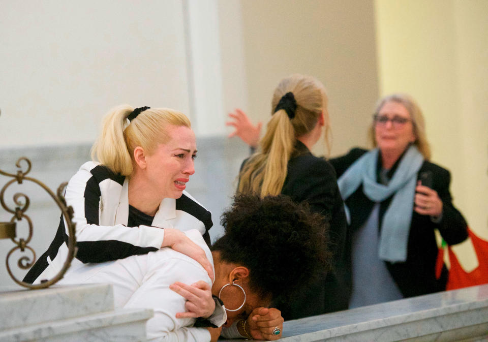 FILE - In this April 26, 2018 file photo, Bill Cosby accusers, from left, Caroline Heldman, Lili Bernard and Victoria Valentino, right, react outside the courtroom after Cosby was found guilty in his sexual assault retrial at the Montgomery County Courthouse in Norristown, Pa. Cosby is facing the start of a sentencing hearing on Monday, Sept. 24, 2018, at which a judge will decide how to punish the 81-year-old comedian who was convicted in April of drugging and sexually assaulting former Temple University athletics employee Andrea Constand at his suburban Philadelphia home in 2004. (Mark Makela/Pool Photo via AP)