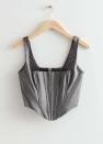 <p>40€</p><br><a href="https://www.stories.com/fr_fr/clothing/tops/tanktops-camisoles/product.metallic-corset-top-grey.1098596002.html?gclid=Cj0KCQjw8qmhBhClARIsANAtbodpJOdAtEqfkdl_GxnIV3L0rmuASLA7rQoG02gD3LyuOXqsuGNXQaEaAl4BEALw_wcB" rel="nofollow noopener" target="_blank" data-ylk="slk:Acheter;elm:context_link;itc:0;sec:content-canvas" class="link ">Acheter</a>