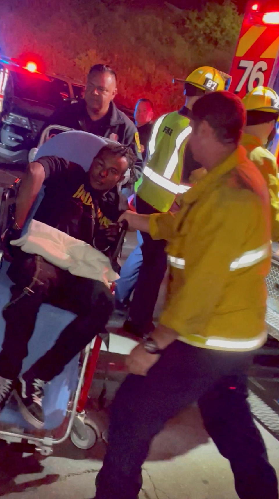 A man is transported into an ambulance after comedian Dave Chappelle was attacked on stage during stand-up Netflix show at the Hollywood Bowl, in Los Angeles, May 3, 2022, in this still image obtained from a social media video. / Credit: Theodore Nwajei/via REUTERS