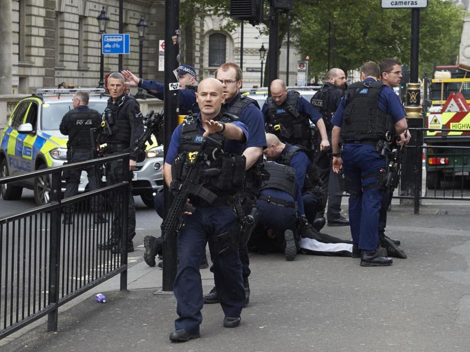 Firearms officiers from the British police arrest a man on Whitehall near the Houses of Parliament (NIKLAS HALLE'N/AFP/Getty Images)