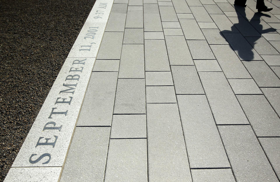 ARLINGTON, VA - JUNE 28: A woman walks on the ground of the Pentagon Memorial June 28, 2011 in Arlington, Virginia. This year is the 10th anniversary of the September 11 terrorist attacks, in which 184 people were killed at the Pentagon. (Photo by Alex Wong/Getty Images)