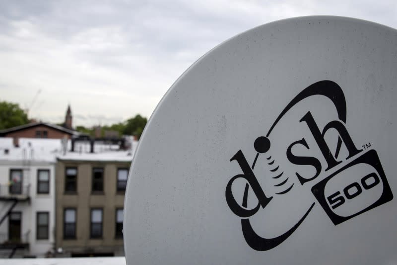 A Dish Network logo is seen on a satellite dish on a Brooklyn apartment building roof in New York June 4, 2015. REUTERS/Brendan McDermid