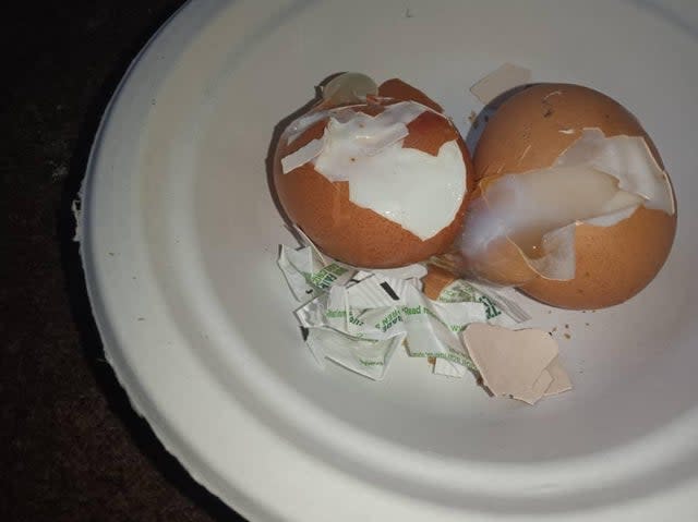 A photo shows eggs that appear to be undercooked, which asylum seekers say they were served at the Penally military camp