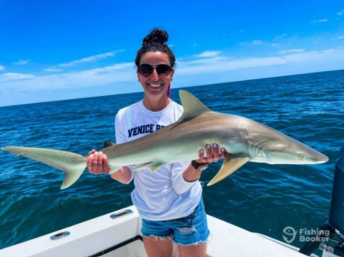 A woman holds up a Blacknose shark she caught while on a fishing trip with Captain Tony Zain of Skyway Sportfishing, a charter service on Anna Maria Island. Zain is one of six charter boat fishermen named 2022 Angler’s Choice Award winners.