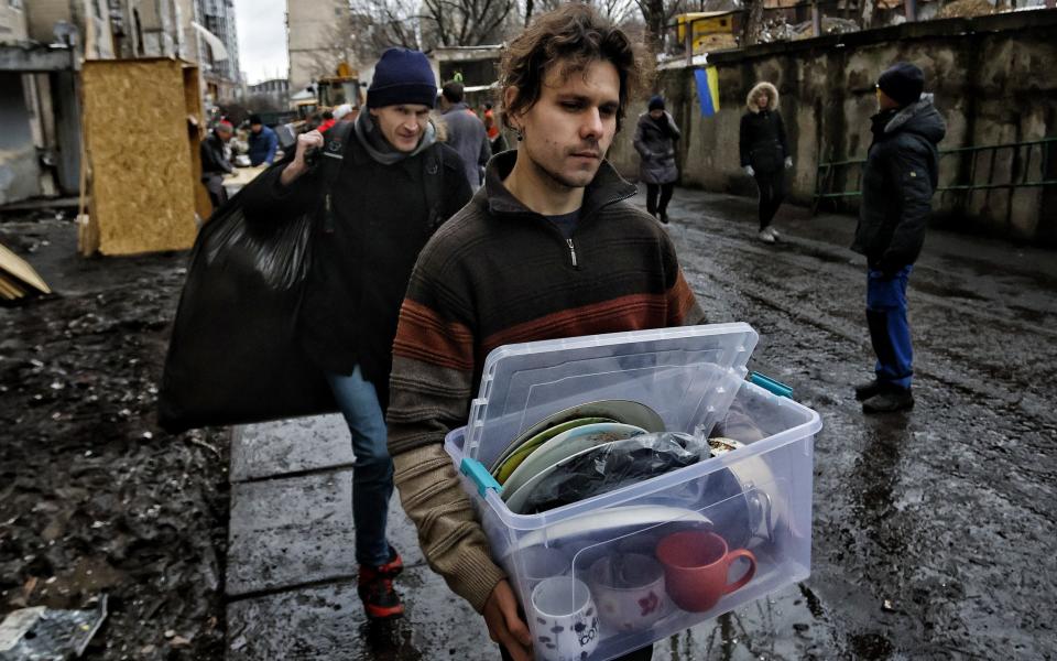 Residents retrieve personal belongings from badly damaged homes in Kyiv