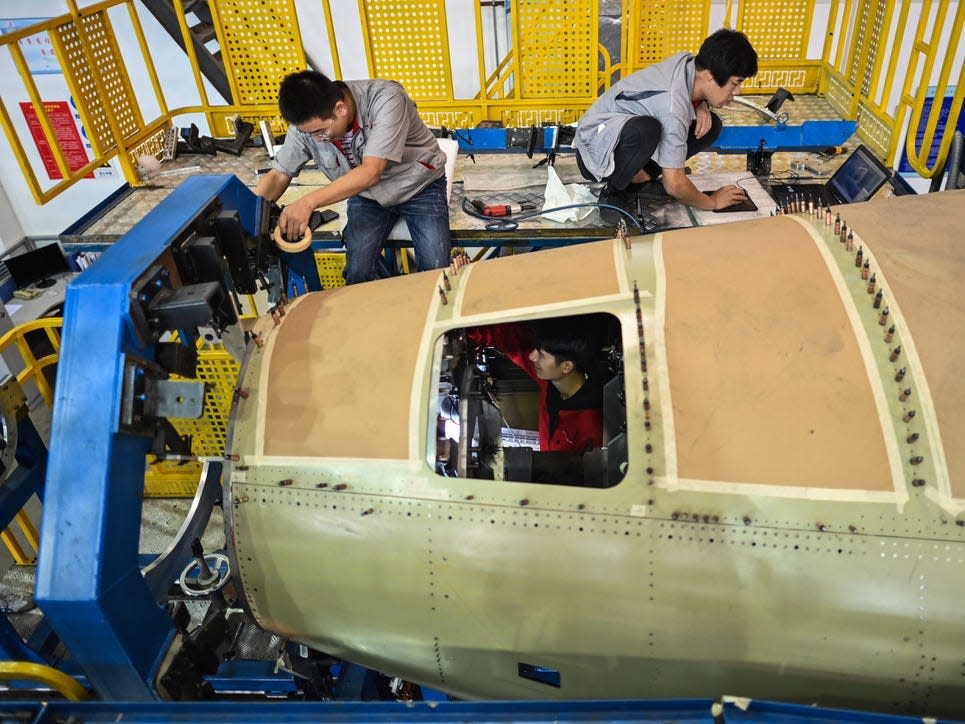 Employees working on the C919.