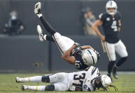 <p>Oakland Raiders wide receiver Seth Roberts (10) falls over Los Angeles Chargers defensive back Jahleel Addae (37) as he is tackled during the second half of an NFL football game in Oakland, Calif., Sunday, Nov. 11, 2018. (AP Photo/John Hefti) </p>