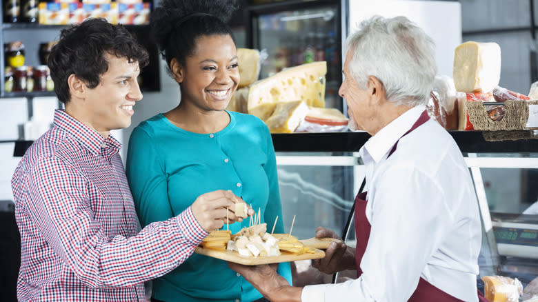 offering cheese samples to customers