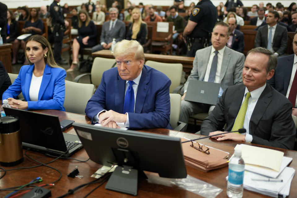FILE - Former President Donald Trump, center, flanked by his defense attorneys, Alina Habba, left, and Chris Kiss, waits for the continuation of his civil business fraud trial at New York Supreme Court, Oct. 25, 2023, in New York. Trump's testimony on Monday will produce a rare spectacle of a former president being summoned to the stand as a trial witness. But Trump has actually had ample experience fielding questions from lawyers. His rhetorical style during years of depositions before becoming president could yield clues as to the approach he'll take when he testifies this week. (AP Photo/Seth Wenig, Pool)