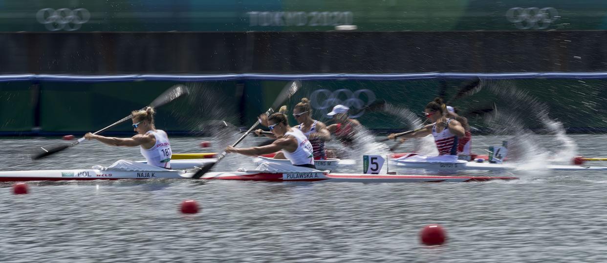 Karolina Naja and Anna Pulawska of Poland (5), Manon Hostens and Sarah Guyot of France (4) and Li Dongyin and Zhou Yu of China (3) compete in the women's kayak double 500m heat during the 2020 Summer Olympics, Monday, Aug. 2, 2021, in Tokyo, Japan.