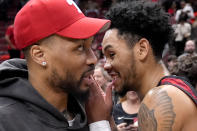 Milwaukee Bucks' Damian Lillard, left, talks with former teammate Portland Trail Blazers' Anfernee Simons after an NBA basketball game between the Chicago Bulls and the Trail Blazers Monday, March 18, 2024, in Chicago. (AP Photo/Charles Rex Arbogast)