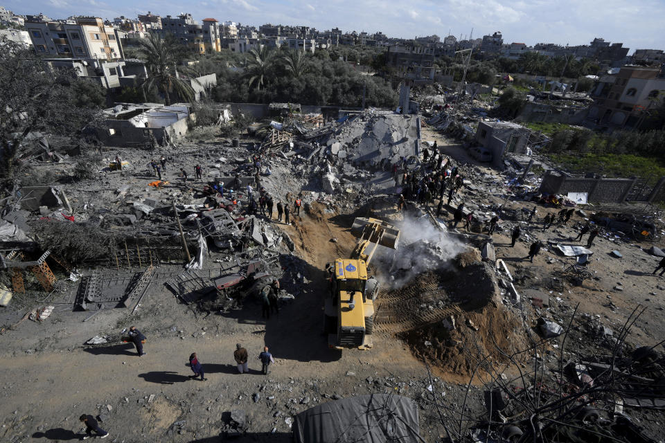 Palestinians search for survivors after an Israeli airstrike on building of Rayan family in Nusseirat refugee camp, central Gaza Strip, Thursday, Feb. 15, 2024. (AP Photo/Adel Hana)