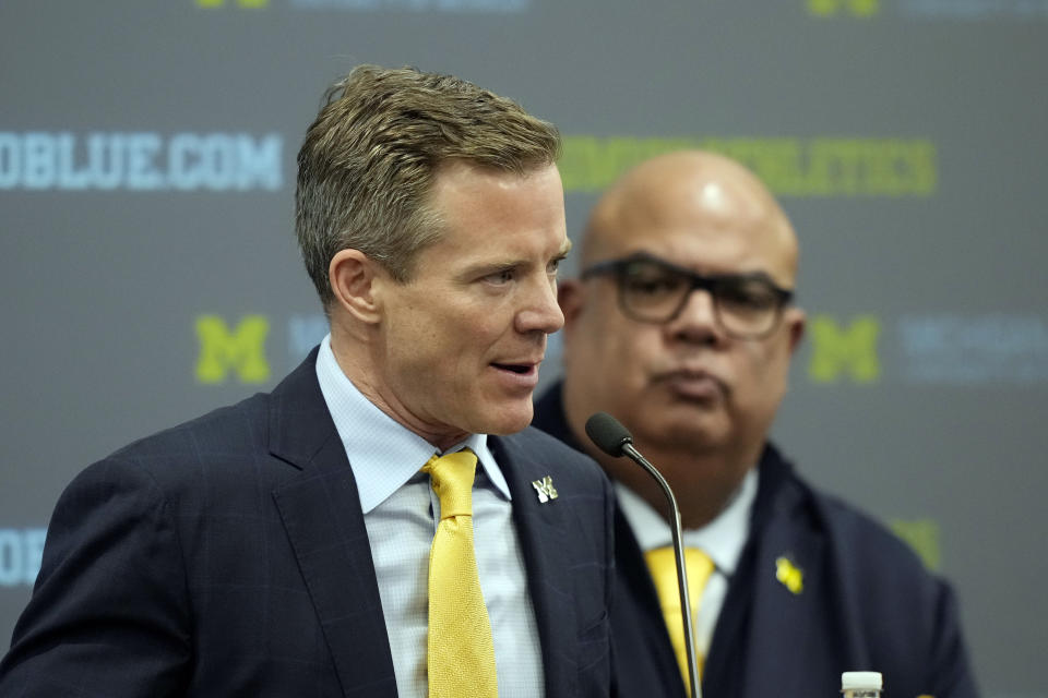 University of Michigan new NCAA college basketball head coach Dusty May addresses the media as Athletic Director Warde Manuel looks on during a news conference, Tuesday, March 26, 2024, in Ann Arbor, Mich. (AP Photo/Carlos Osorio)