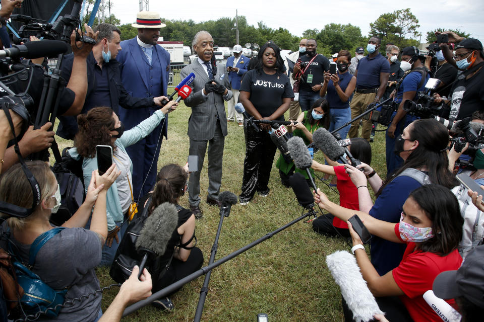 The Rev. Al Sharpton, center, speaks at a news conference as Rev Robert Turner, left, and Tiffany Crutcher look on before a Juneteenth rally in Tulsa, Okla., Friday, June 19, 2020,. Juneteenth marks the day in 1865 when federal troops arrived in Galveston, Texas, to take control of the state and ensure all enslaved people be freed, more than two years after the Emancipation Proclamation. (AP Photo/Sue Ogrocki)