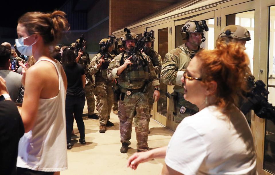 Mall customers run out as heavily armed SWAT Team members enter the Danbury Mall after reports of shots fired in the mall Aug. 11, 2021  