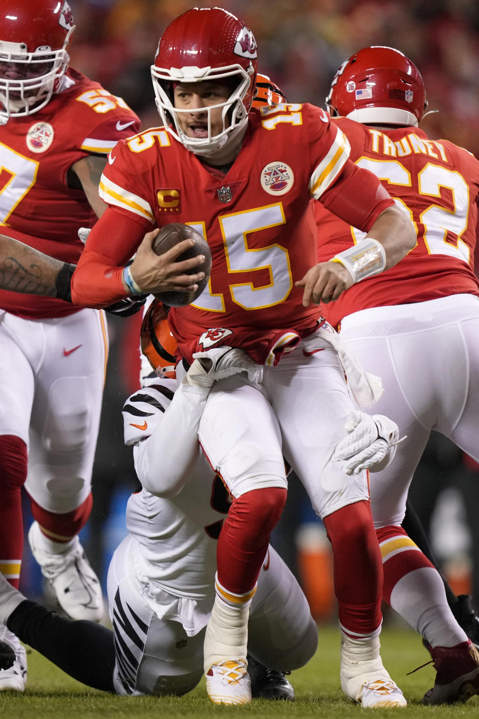 Cincinnati Bengals defensive end Cam Sample tackles Kansas City Chiefs quarterback Patrick Mahomes (15) during the first half of the NFL AFC Championship playoff football game, Sunday, Jan. 29, 2023, in Kansas City, Mo. (AP Photo/Charlie Riedel)