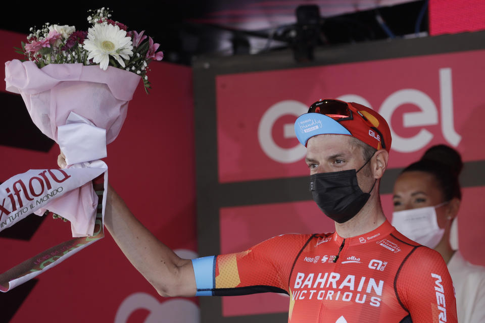 Italy's Damiano Caruso celebrates on podium his second place after completing the final stage to win the Giro d'Italia cycling race, in Milan, Italy, Sunday, May 30, 2021. (AP Photo/Luca Bruno)