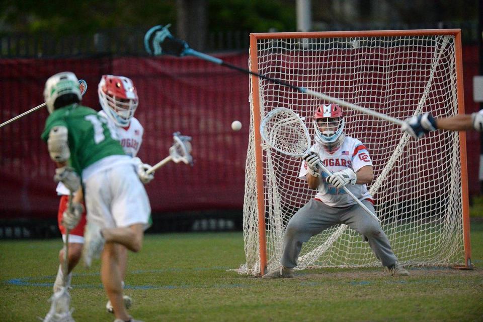 Myers Park’s #11, Max Forsyth scores a first half goal against Charlotte Catholic’s #21, Brady Kam. Charlotte Catholic, ranked #1 in North Carolina and #3 nationally put a perfect, 13-0 record, on the line against 6-3 Myers Park for a match of boys lacrosse teams. The teams were tied 9-9 after the first half. Catholic’s Jack Ransom, a Georgetown recruit, is a standout player. The teams battled on Monday, April 8, 2024. John D. Simmons/Special to the Observer