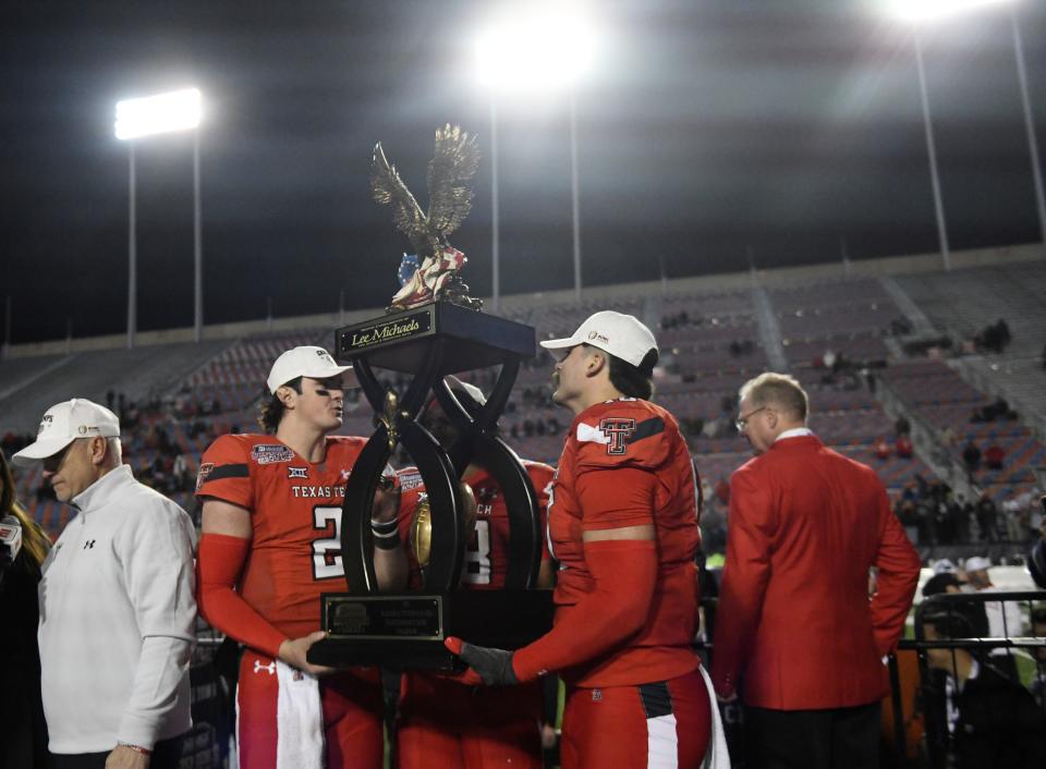 Texas Tech quarterback Behren Morton (2) and linebacker Jacob Rodriguez hoist the Independence Bowl trophy after the Red Raiders beat California 34-14 Saturday night in Shreveport, Louisiana. Morton and Rodriguez were named the game's outstanding offensive and defensive player, respectively.