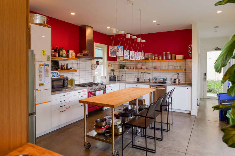 Red painted walls in kitchen of communal home.