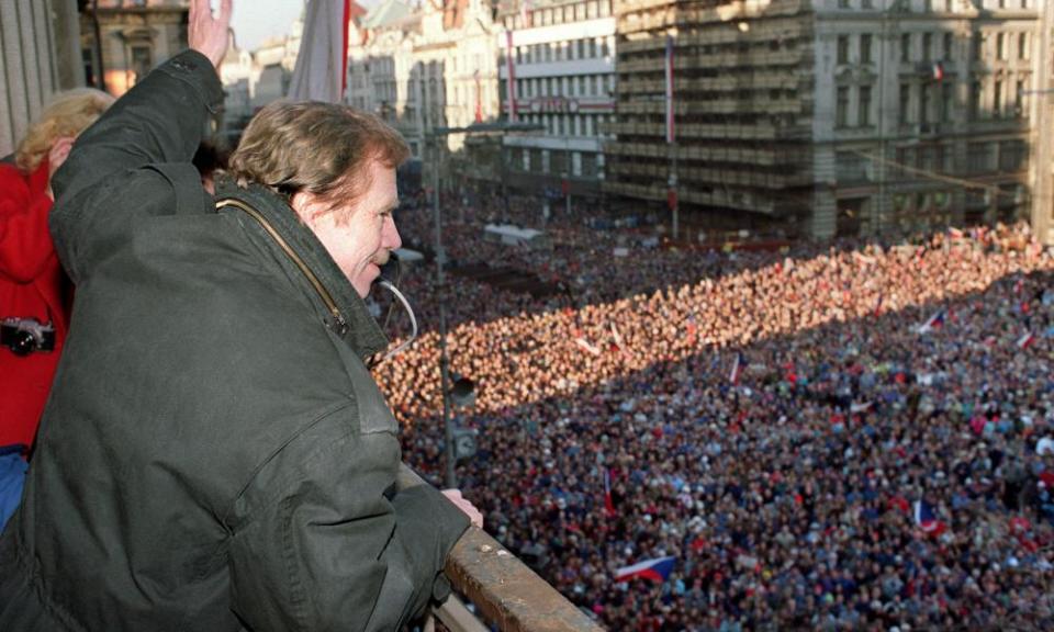 Václav Havel waves to a crowd of thousands of demonstrators on 10 December 1989 in Prague’s Wenceslas Square, celebrating the communist capitulation.