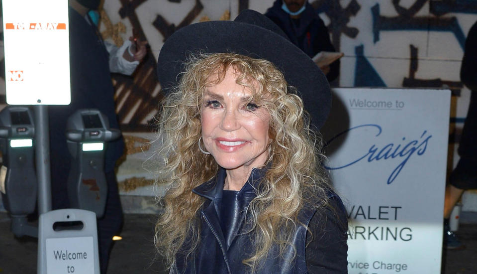 Dyan Cannon in a black leather jacket and hat.