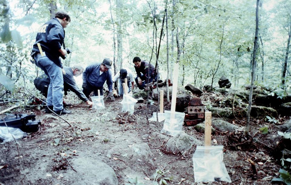 Authorities search for the remains of Steven M. Hicks, Jeffrey Dahmer's first victim, outside Dahmer's parents' home in Bath Township on July 31, 1991.