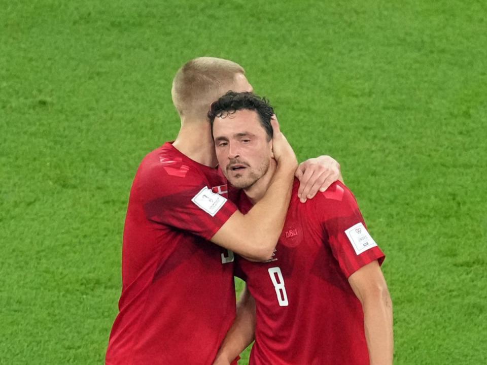 Thomas Delaney (right) is consoled by Rasmus Kristensen while going off injured (PA)