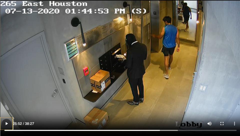 A CCTV screenshot of Tyrese Haspil and Fahim Saleh in the lobby of condo complex.