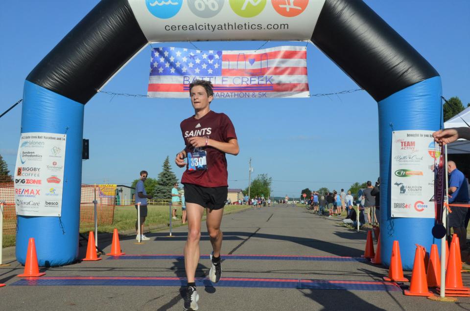 Connor Callahan of Grand Rapids wins the 2022 Battle Creek Half Marathon after passing through the grounds of the Field of Flight on Saturday.