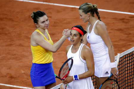 Tennis - Fed Cup - World Group Semi-Final - France v Romania - Kindarena, Rouen, France - April 21, 2019 France's Kristina Mladenovic and Caroline Garcia shakes hands with Romania's Simona Halep after winning their doubles match with Monica Niculescu REUTERS/Charles Platiau