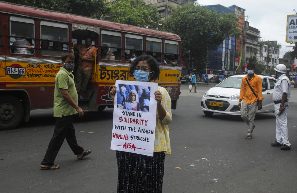 A student holds a placard in solidarity with the women of Afghanistan as activists of All India Students Association (AISA) hold a demonstration in Kolkata, India, Wednesday, Aug.18, 2021. (AP Photo/ Ashok Nath Dey)