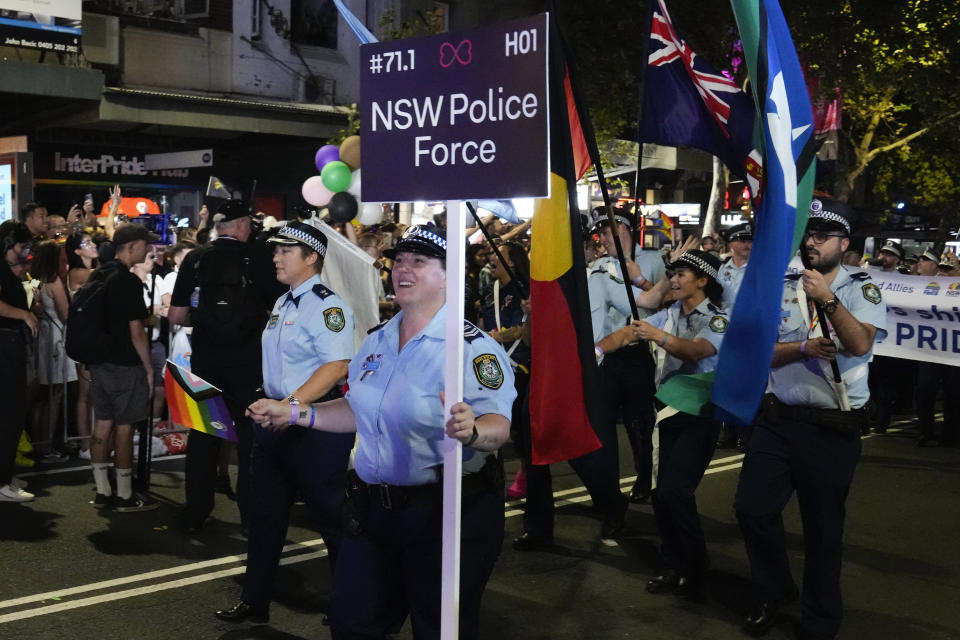 Members of the New South Wales police react as they march in the 45th Anniversary Sydney Gay and Lesbian Mardi Gras Parade in Oxford Street, Sydney, Australia, Saturday, Feb. 25, 2023. Organizers of the Sydney Gay and Lesbian Mardi Gras have asked police not to march at their annual parade at the weekend due to an alleged murder of a couple by a police officer, prompting the police commissioner on Tuesday, Feb, 27, 2024, to urge the ban be reversed. (AP Photo/Mark Baker)