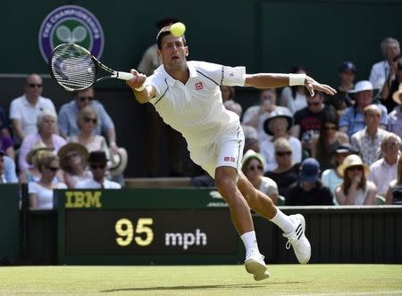 Novak Djokovic of Serbia hits a shot during his match against Jarkko Nieminen of Finland at the Wimbledon Tennis Championships in London, July 1, 2015. REUTERS/Toby Melville