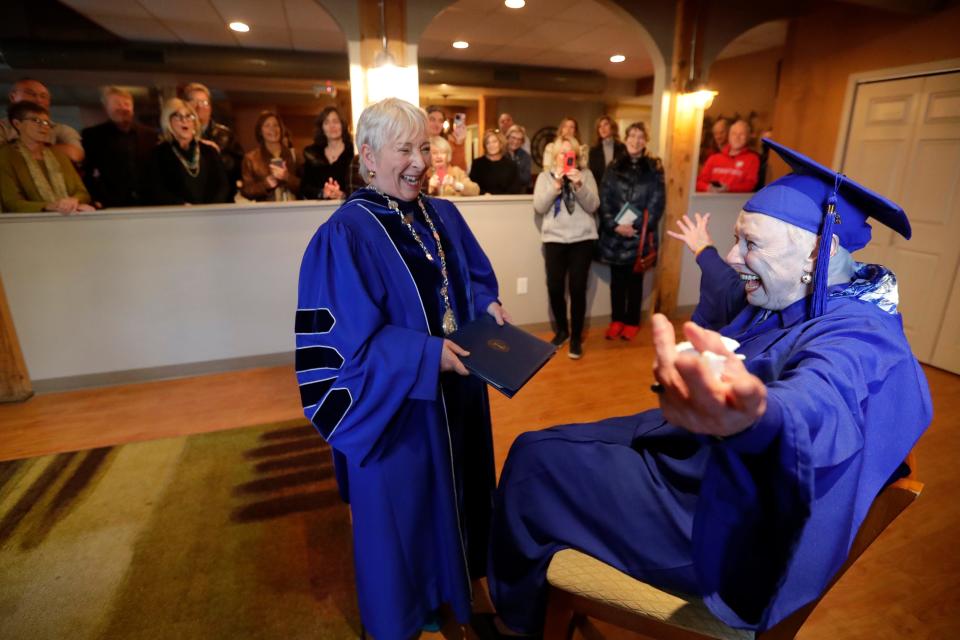 Rosemary Lloyd, 88, right, of Appleton is excited as she receives her bachelor's degree from Marian University president Michelle Majewski Wednesday, November 9, at the Historic Fox River Mills Apartments 
in Appleton, Wis.