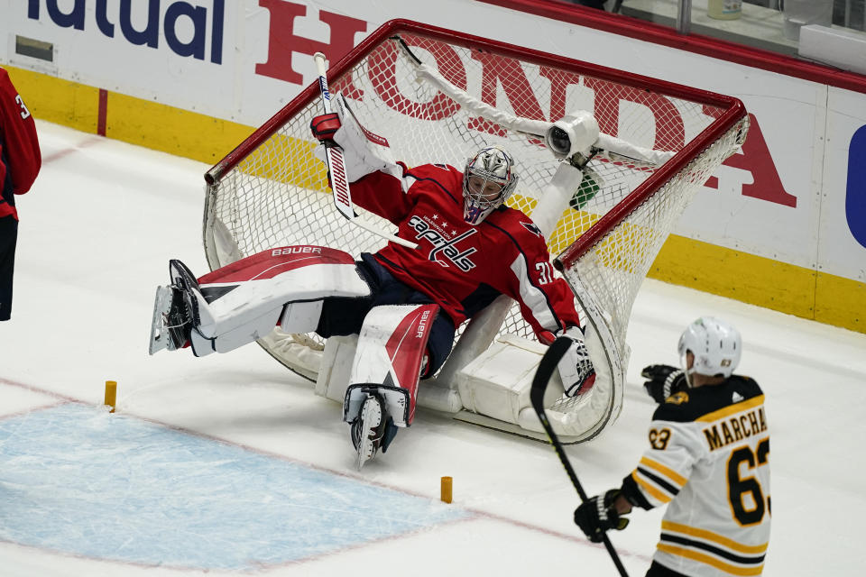 Washington Capitals goaltender Craig Anderson (31) falls into the net during the first period of Game 1 of the team's NHL hockey Stanley Cup first-round playoff series against the Boston Bruins, Saturday, May 15, 2021, in Washington. (AP Photo/Alex Brandon)