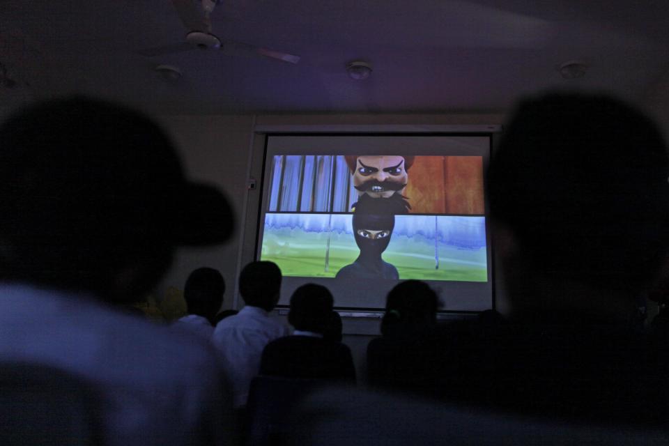 In this Monday, March 25, 2013, photo, Pakistani orphans watch an early screening of the first episode of the animates Burka Avenger series, at an orphanage on the outskirts of Islamabad, Pakistan. Wonder Woman and Supergirl now have a Pakistani counterpart in the pantheon of female superheroes _ one who shows a lot less skin. Meet Burka Avenger: a mild-mannered teacher with secret martial arts skills who uses a flowing black burka to hide her identity as she fights local thugs seeking to shut down the girls' school where she works. Sadly, it's a battle Pakistanis are all too familiar with in the real world.(AP Photo/Muhammed Muheisen)