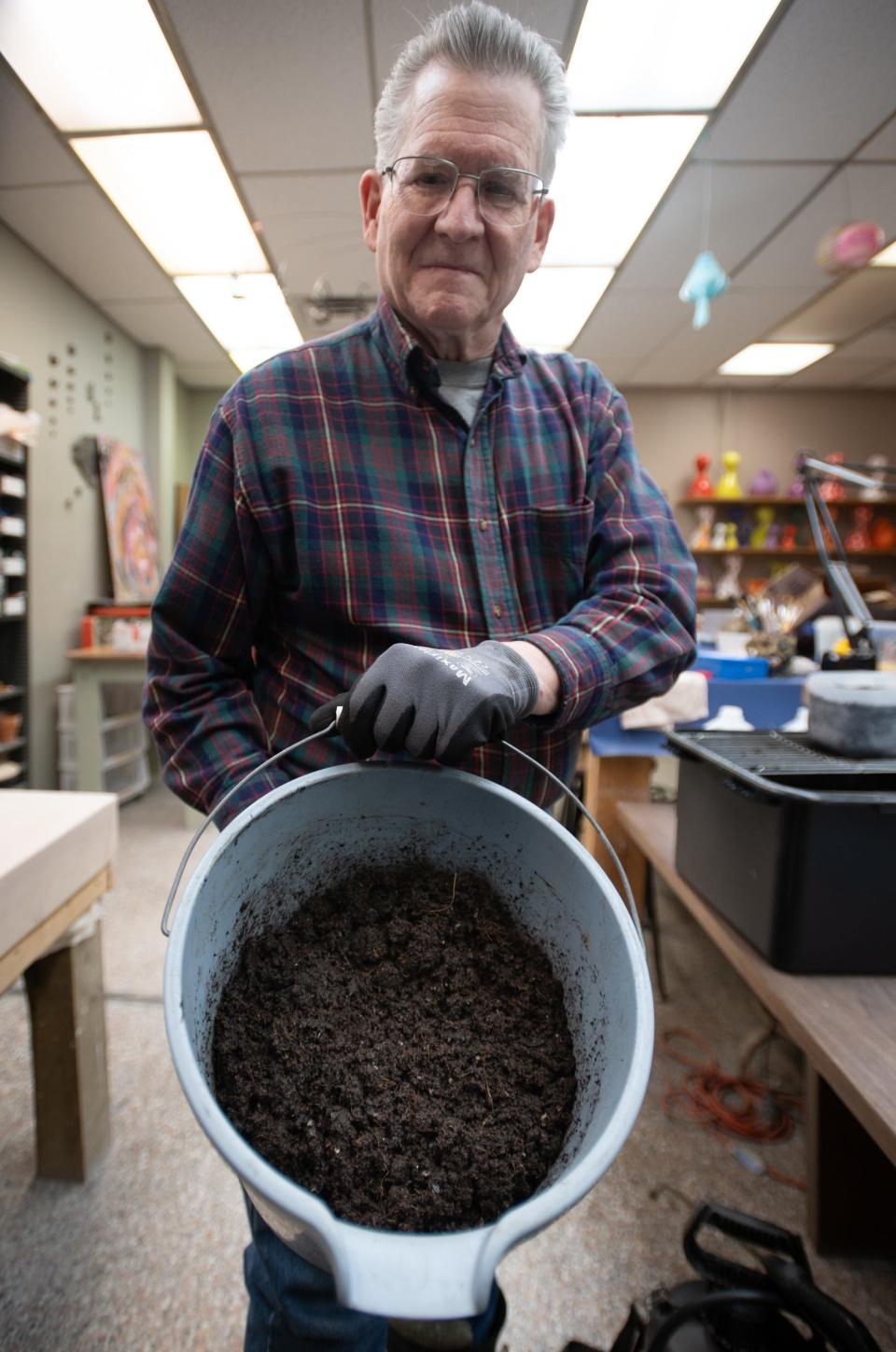 Kim Ellingwood of Lansing's Friends of Bancroft Park shows a mix of coconut core, worm casings, potting soil, and charcoal where native seeds will be planted and sown in the milk jug greenhouses he and fellow environmental activist Abby Deneau are preparing Wednesday, Jan. 17, 2024.