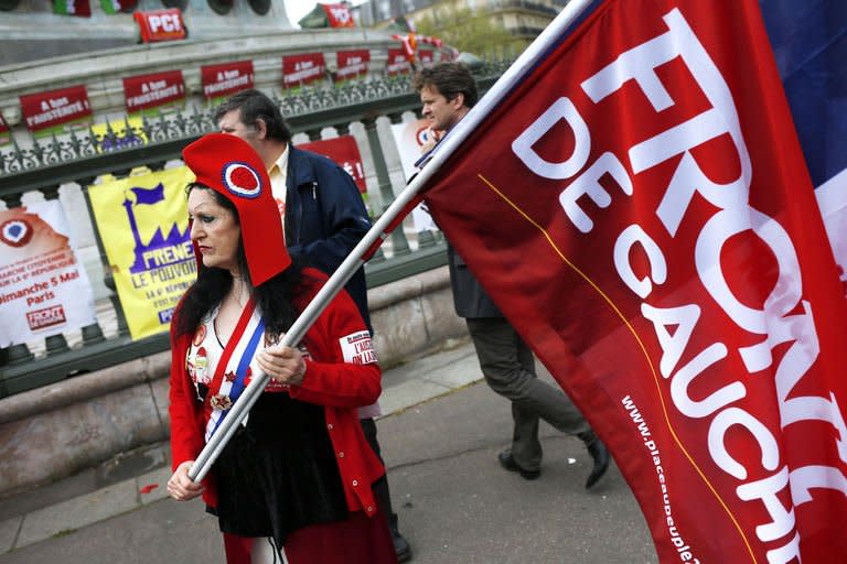 A protester dressed up as Marianne, a personification of the French Republic, holds a Front de Gauche (Left Front) flag on May 5, 2013 in Paris