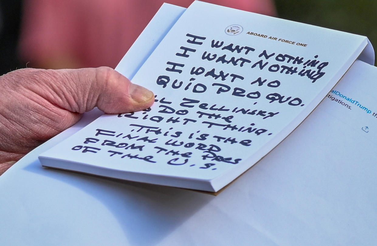 U.S. President Donald Trump holds what appears to be a prepared statement and handwritten notes after watching testimony by U.S. Ambassador to the European Union Gordon Sondland as he speaks to reporters prior to departing for travel to Austin, Texas from the South Lawn of the White House in Washington on November 20, 2019. (Erin Scott/Reuters)