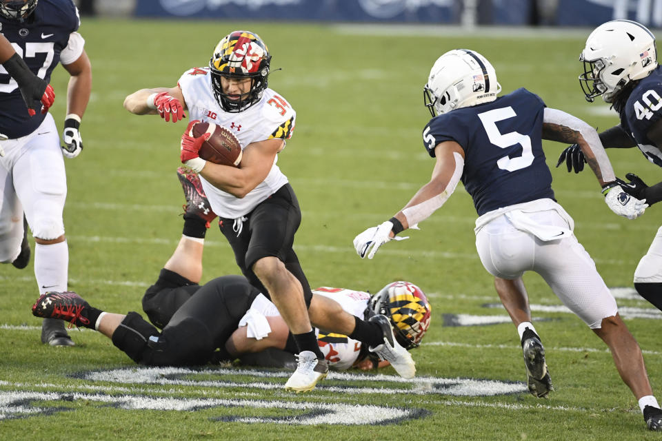 Maryland running back Jake Funk (34) eludes Penn State cornerback Tariq Castro-Fields (5) on a second-quarter touchdown run during an NCAA college football game in State College, Pa., Saturday, Nov. 7, 2020. (AP Photo/Barry Reeger)